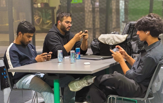 Students sit in the Nexus and play PUBG on their phones