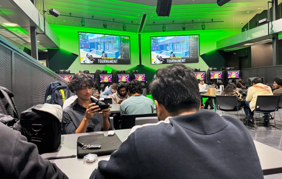 Students sit in the Nexus and play PUBG on their phones