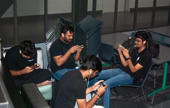 Students sit in the Nexus and play PUBG on their phones