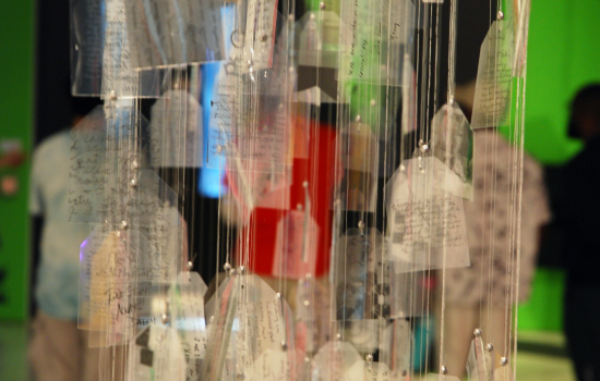 A hanging mobile of notes written on vellum at the Love Languages Exhibit at Art Windsor-Essex