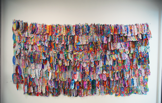 An art piece in the form of rows of hand-drawn paper feathers at Art Windsor-Essex