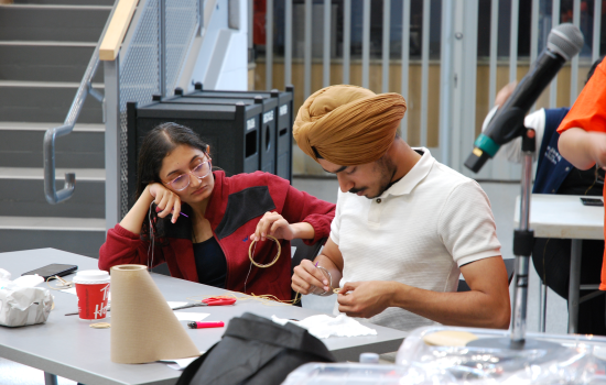 SRC Director Pratham and another student making a dreamcatcher