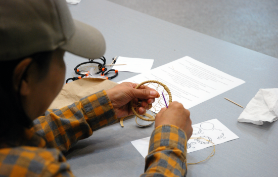 a student making a dreamcatcher