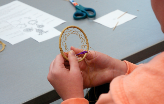 a student making a dreamcatcher