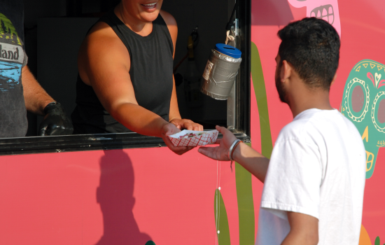 a student purchasing a taco from a food truck