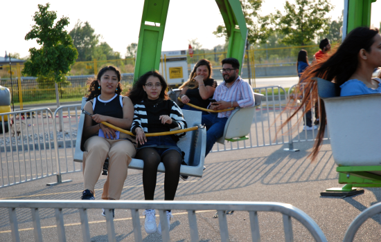 Two students enjoying a carnival ride