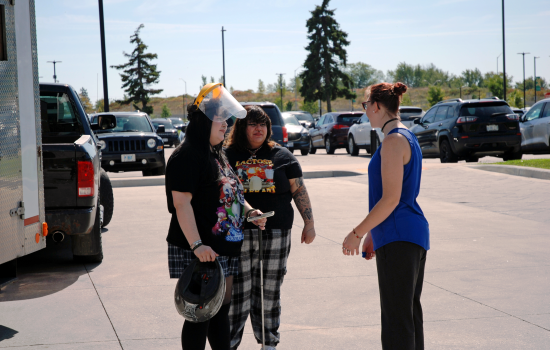 Students wearing helmets waiting for their turn in the Wreck Room trailer