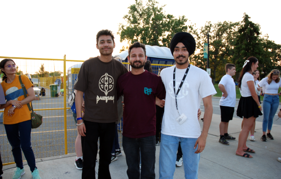 A group of 3 students waiting in line for the DJ Colour Party