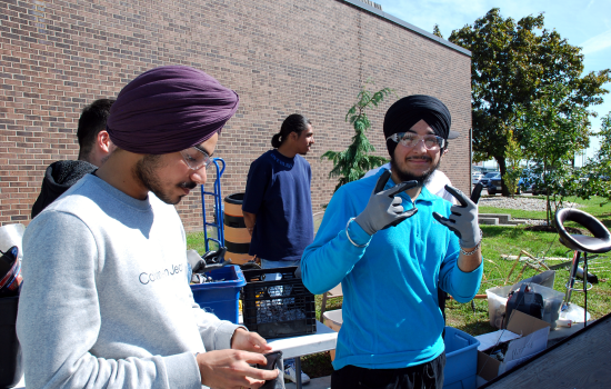 Students putting on protective gloves a goggles