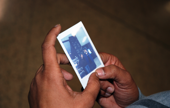 A student holding their polaroid