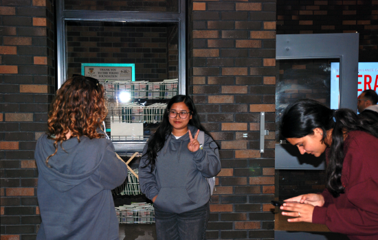 SRC Director Aida taking a photo of a student