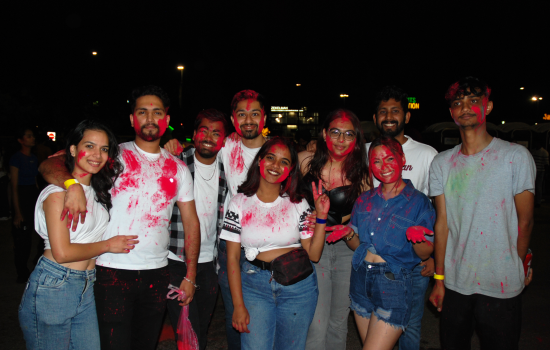 A group of students covered in pink colour chalk