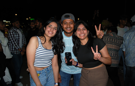 A group of 3 smiling students at the DJ Colour Party