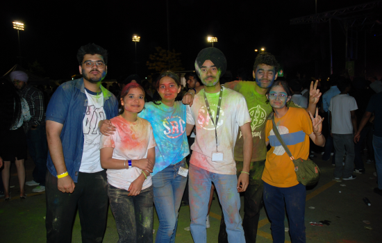 A group of students and student leaders covered in colour chalk