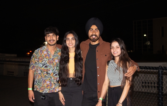 Four students outside waiting to enter the DJ Party