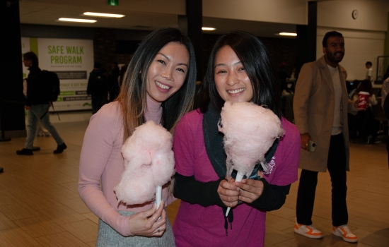 Smiling students pose with their cotton candy
