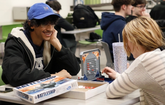 Two students play a game of Battleship